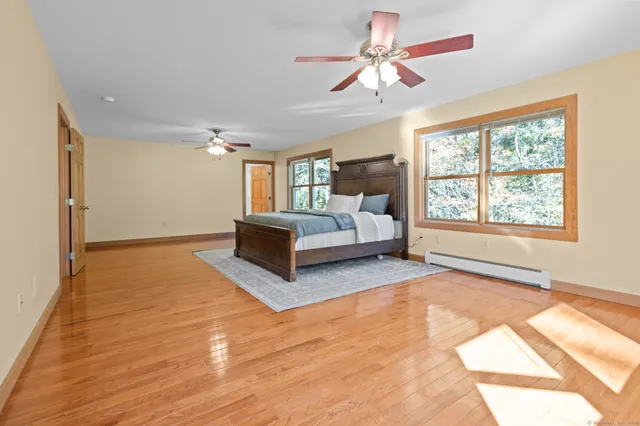 a spacious bedroom with a bed and a large window