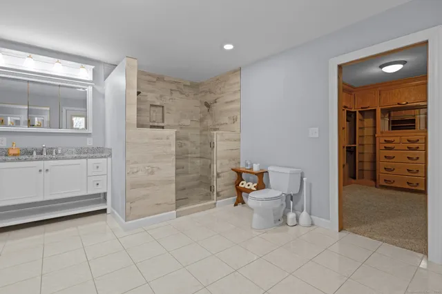 a bathroom with a granite countertop sink a vanity and a mirror
