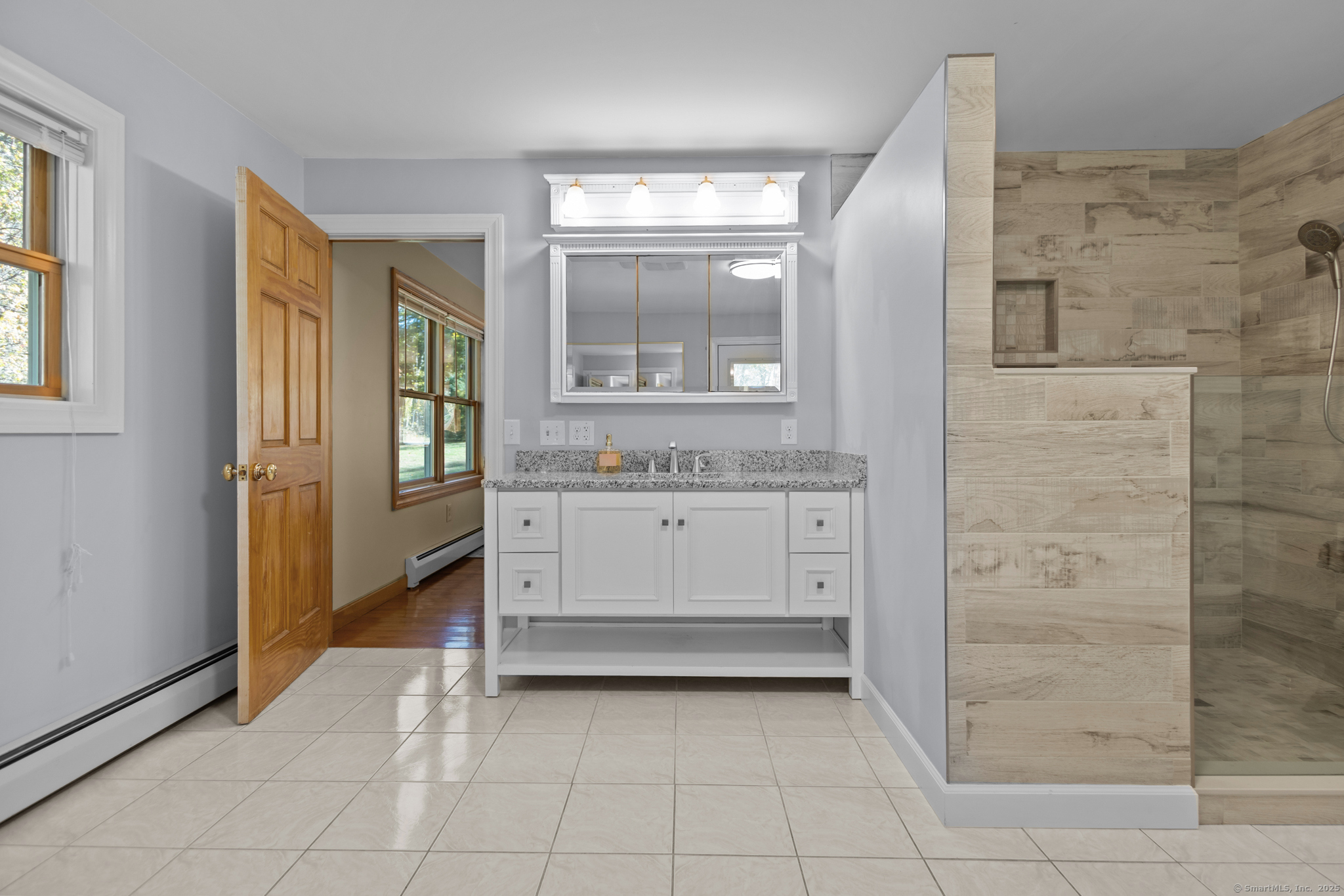 679 Bailey Hill Road Killingly, CT 06241 - Photo 30 of 39 a bathroom with a granite countertop sink a vanity and a mirror