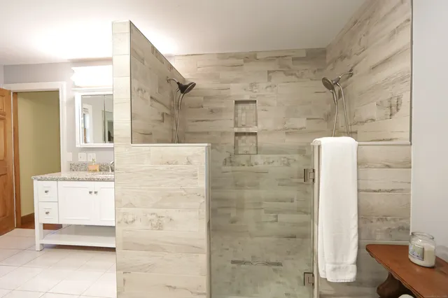 walk in closet with window and glass door