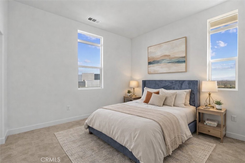 27410 Merlin Place, Unit 305 Valencia, CA 91381 - Photo 13 of 32 a bedroom with a bed and a painting on the wall