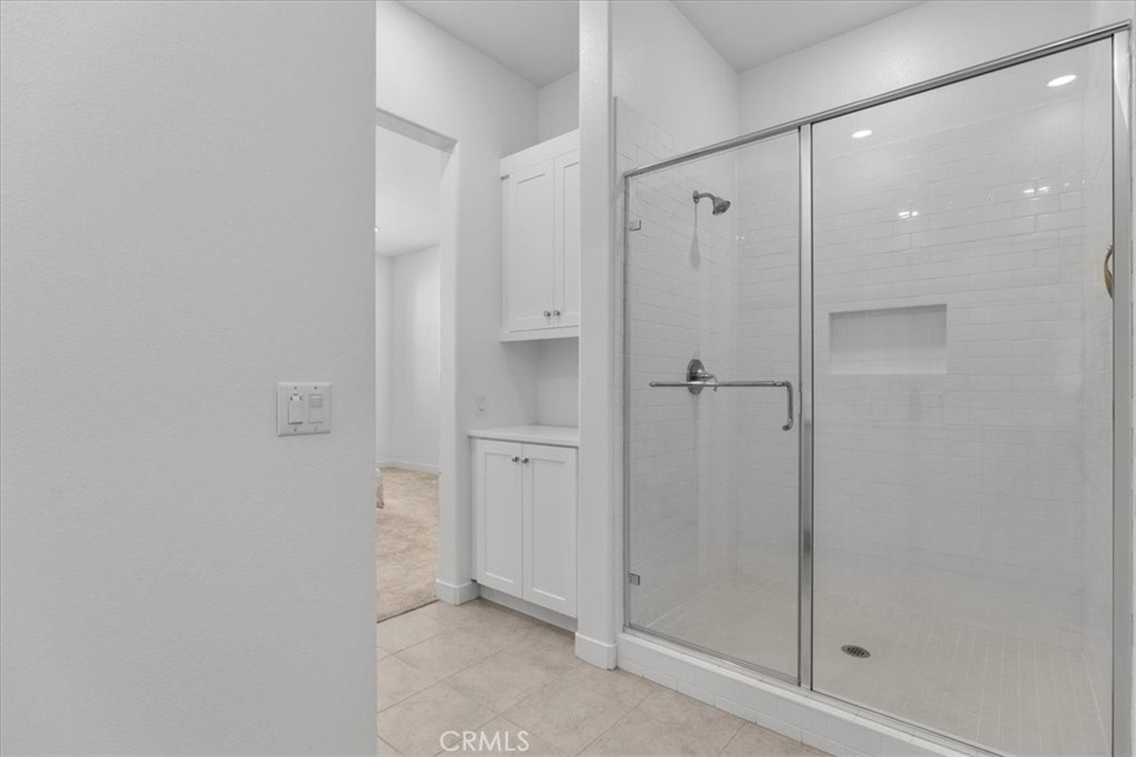 27410 Merlin Place, Unit 305 Valencia, CA 91381 - Photo 15 of 32 a bathroom with a shower and a glass door