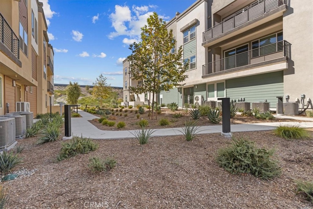 27410 Merlin Place, Unit 305 Valencia, CA 91381 - Photo 24 of 32 a view of a yard in front of a building