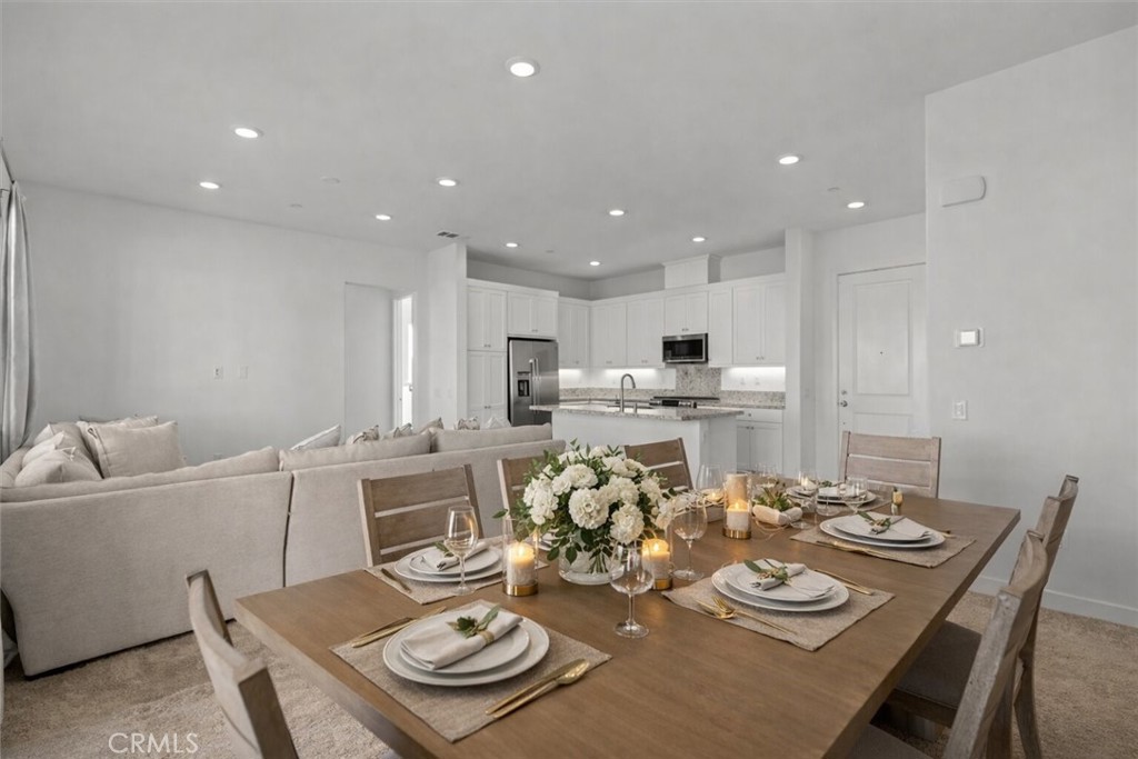 27410 Merlin Place, Unit 305 Valencia, CA 91381 - Photo 6 of 32 a kitchen with a dining table and chairs