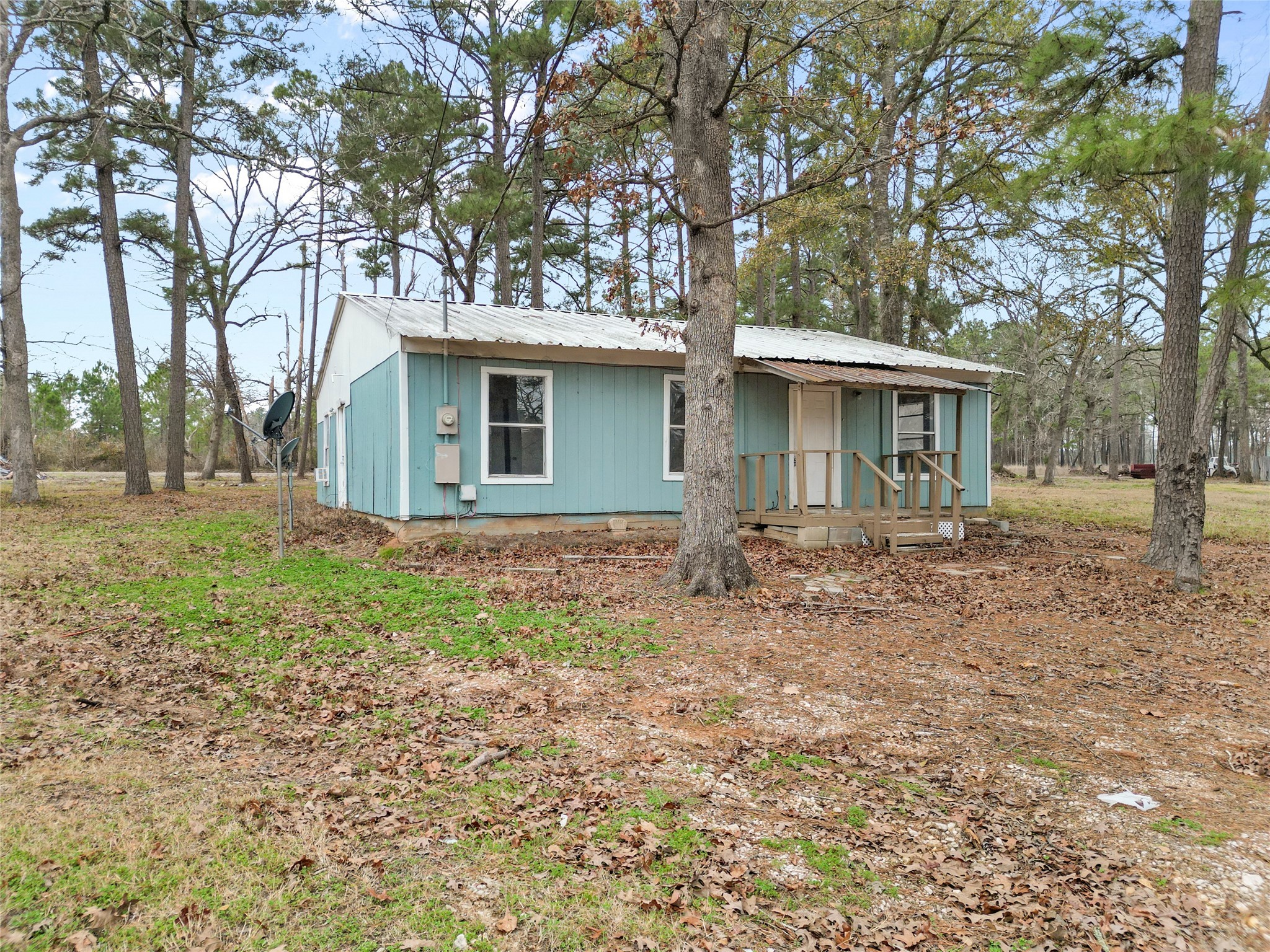 31C Jackson Road, Unit B Huntsville, TX 77320 - Photo 2 of 18 a backyard of a house with barbeque oven table and chairs
