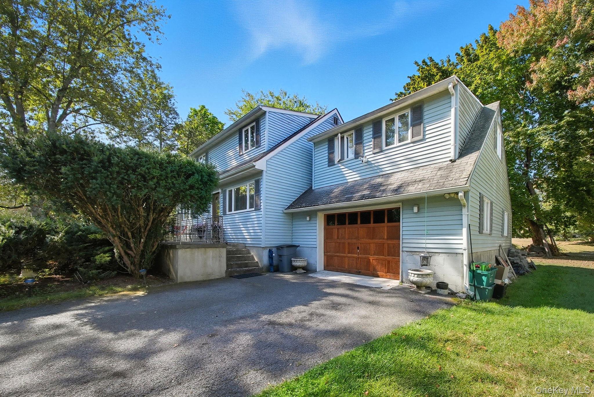 58 James Road Monroe, NY 10950 - Photo 1 of 24 a front view of house with yard and trees in the background