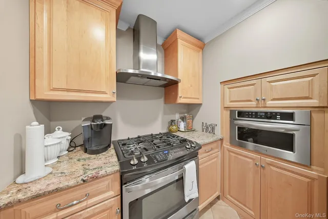 a kitchen with granite countertop stainless steel appliances and cabinets