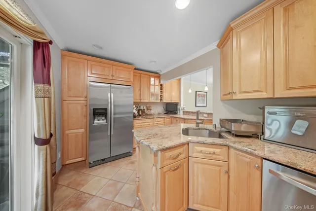 a kitchen with stainless steel appliances granite countertop a refrigerator and a stove