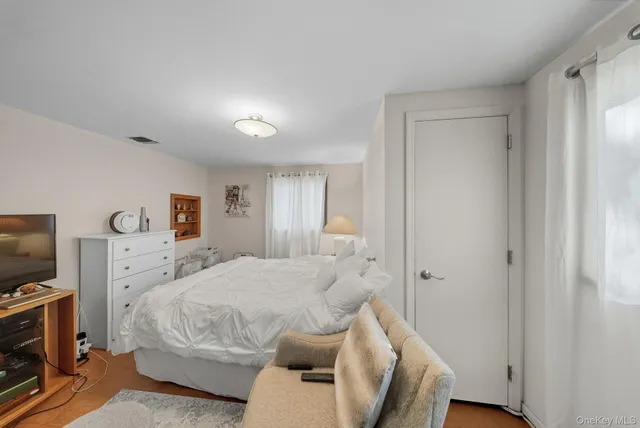 a bedroom with a bed and a tv