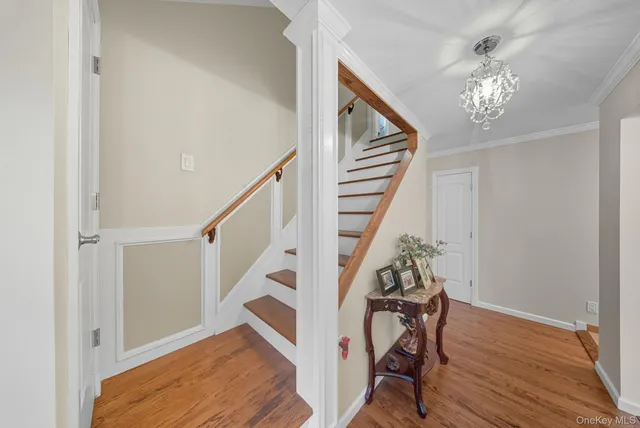a view of entryway and hall with wooden floor