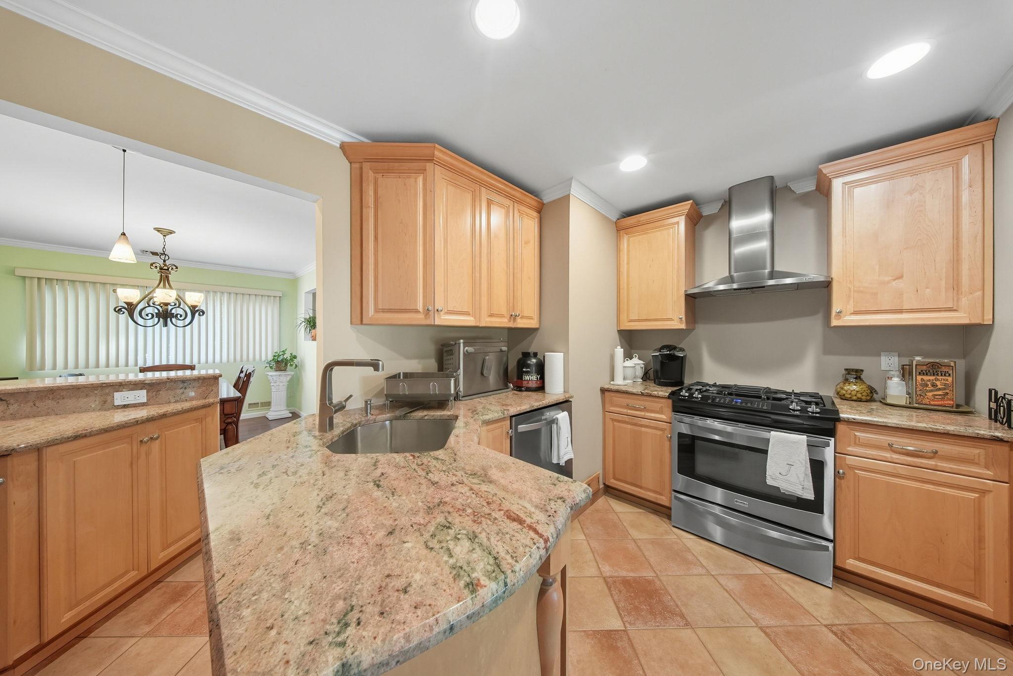 58 James Road Monroe, NY 10950 - Photo 10 of 24 a kitchen with stainless steel appliances granite countertop a stove top oven a sink dishwasher a dining table and chairs with wooden cabinets