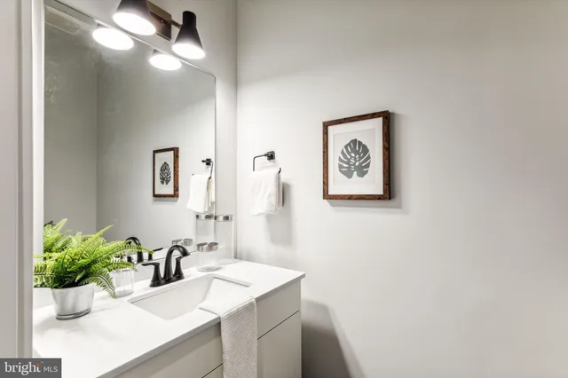a bathroom with a sink mirror and vanity