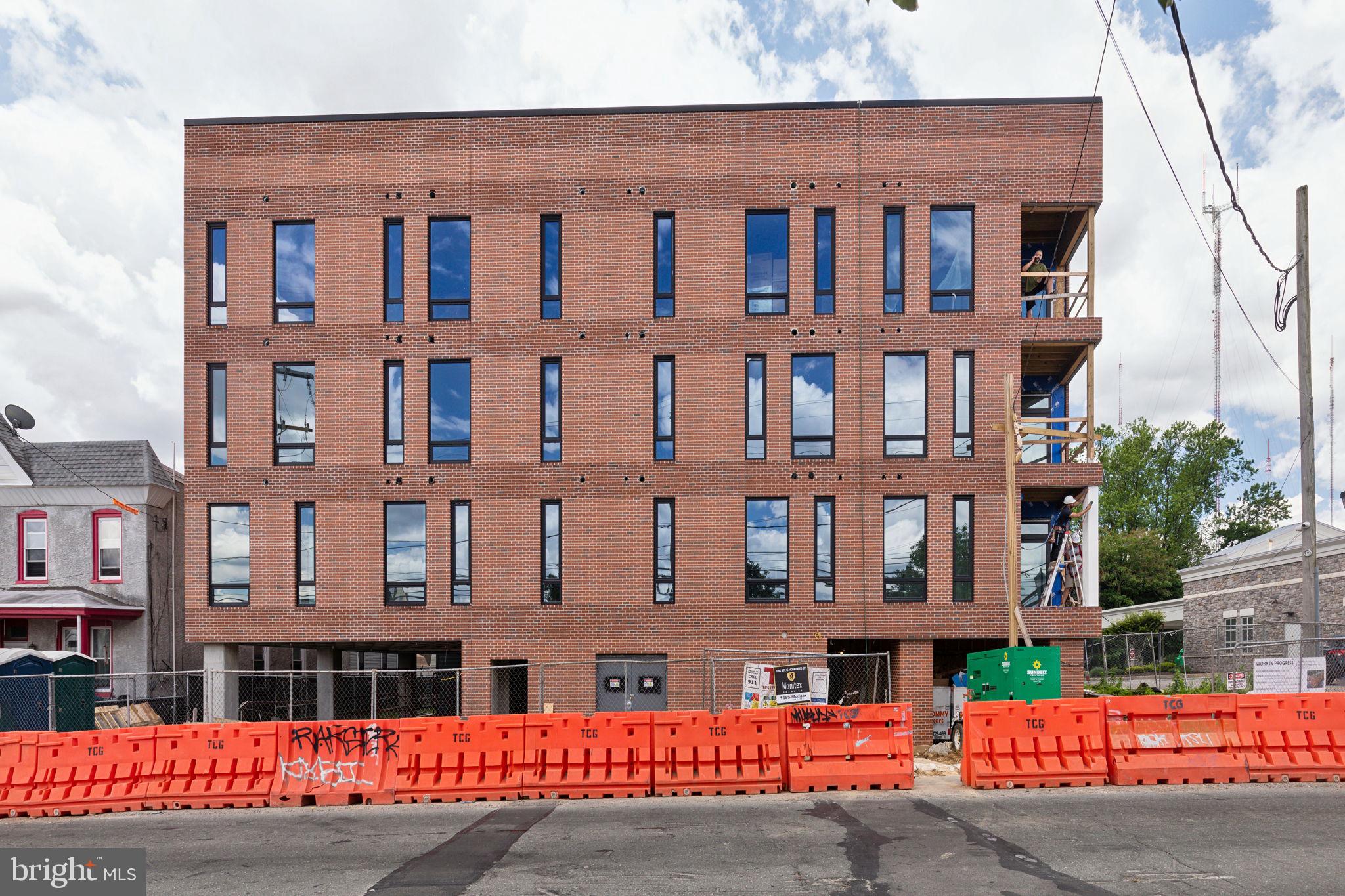 6910 Ridge Avenue, Unit 110 Philadelphia, PA 19128 - Photo 18 of 19 a front view of a building with a street