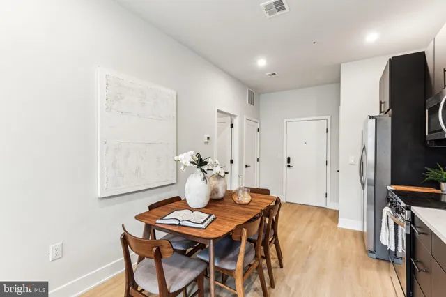 a view of a dining room with furniture and wooden floor