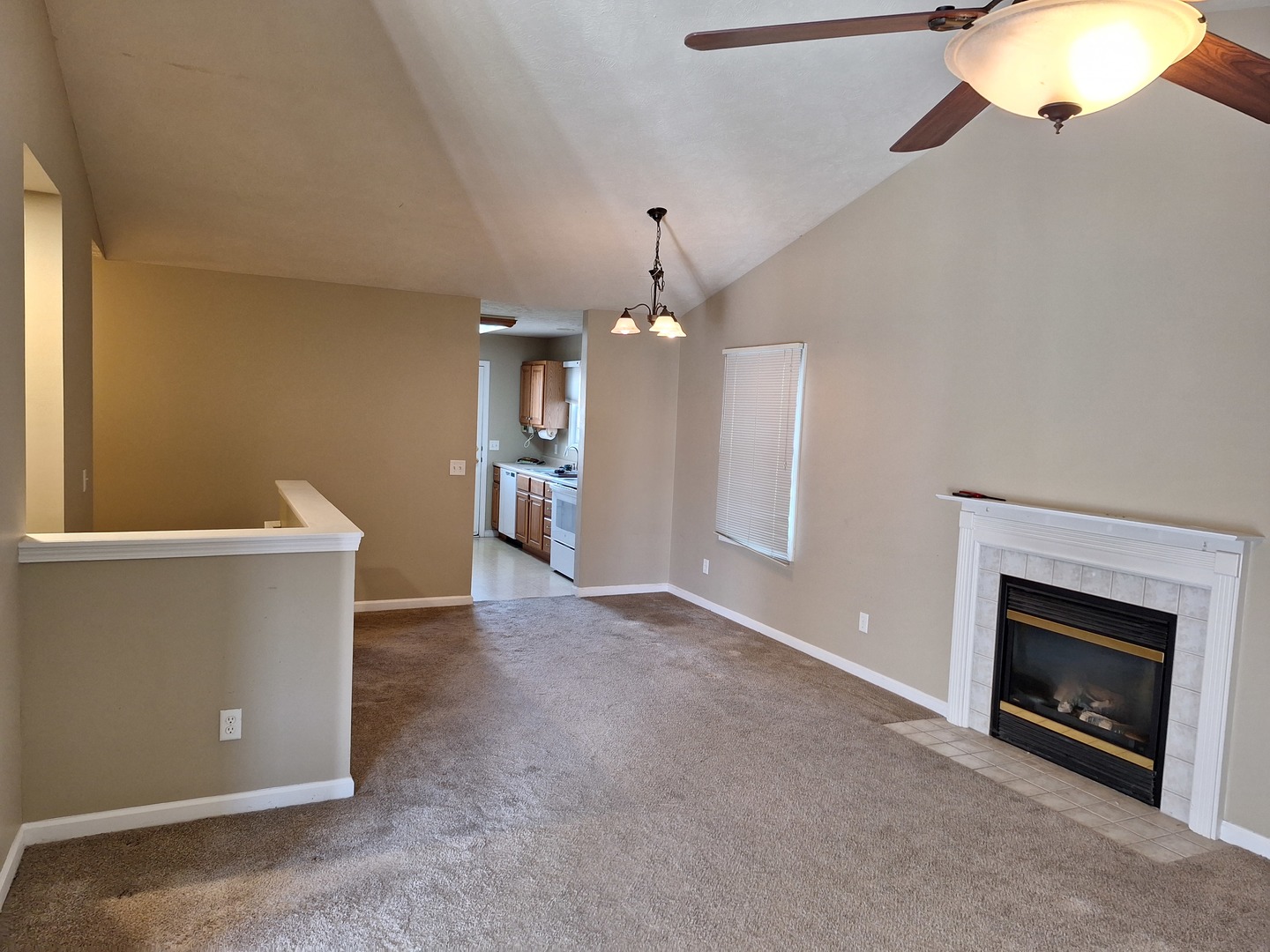 1104 Whitaker Street Normal, IL 61761 - Photo 2 of 19 an empty room with a fireplace and chandelier fan