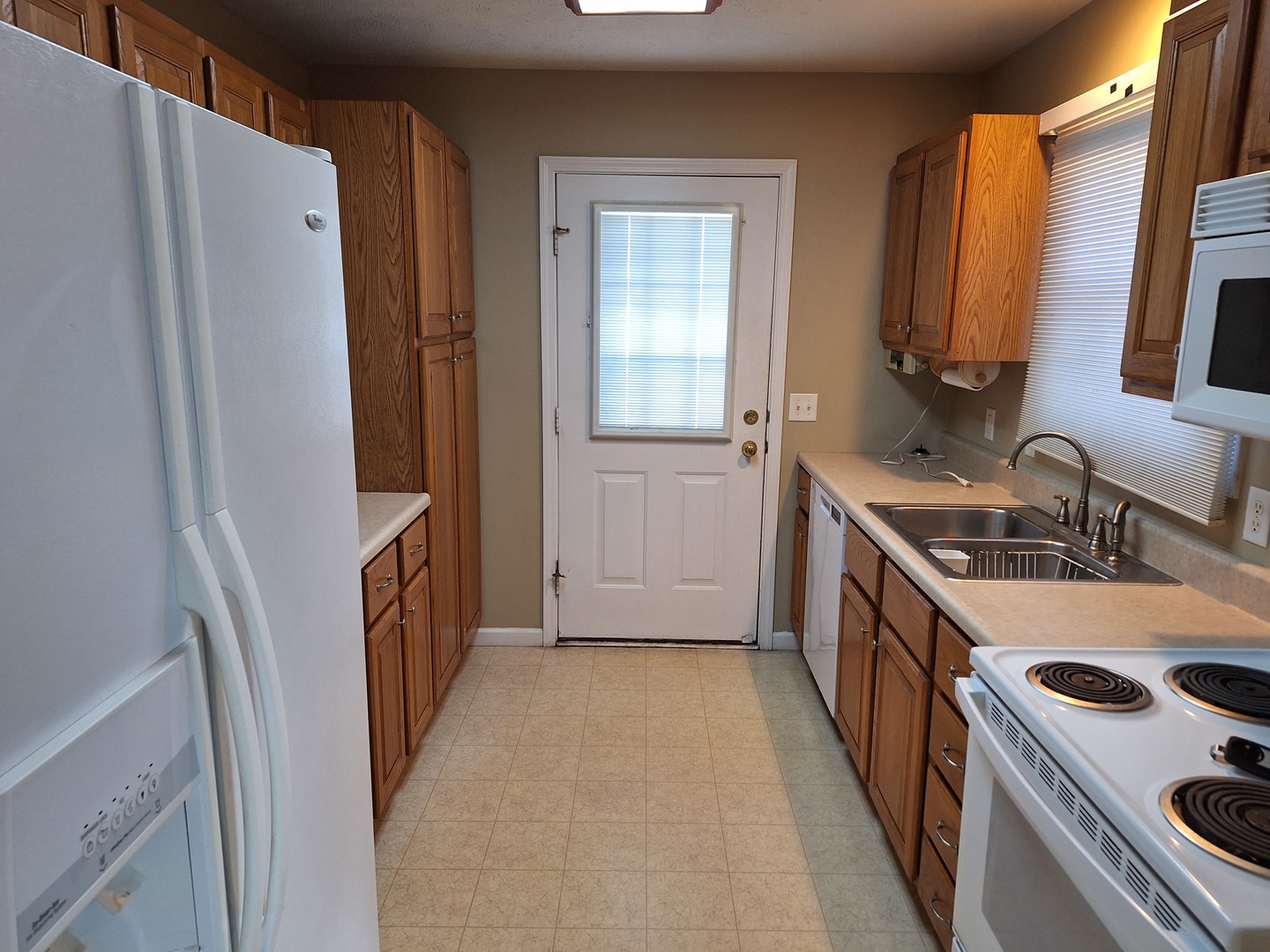 1104 Whitaker Street Normal, IL 61761 - Photo 3 of 19 a kitchen with a sink a refrigerator and a stove top oven
