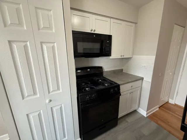 a kitchen with a stove and a microwave