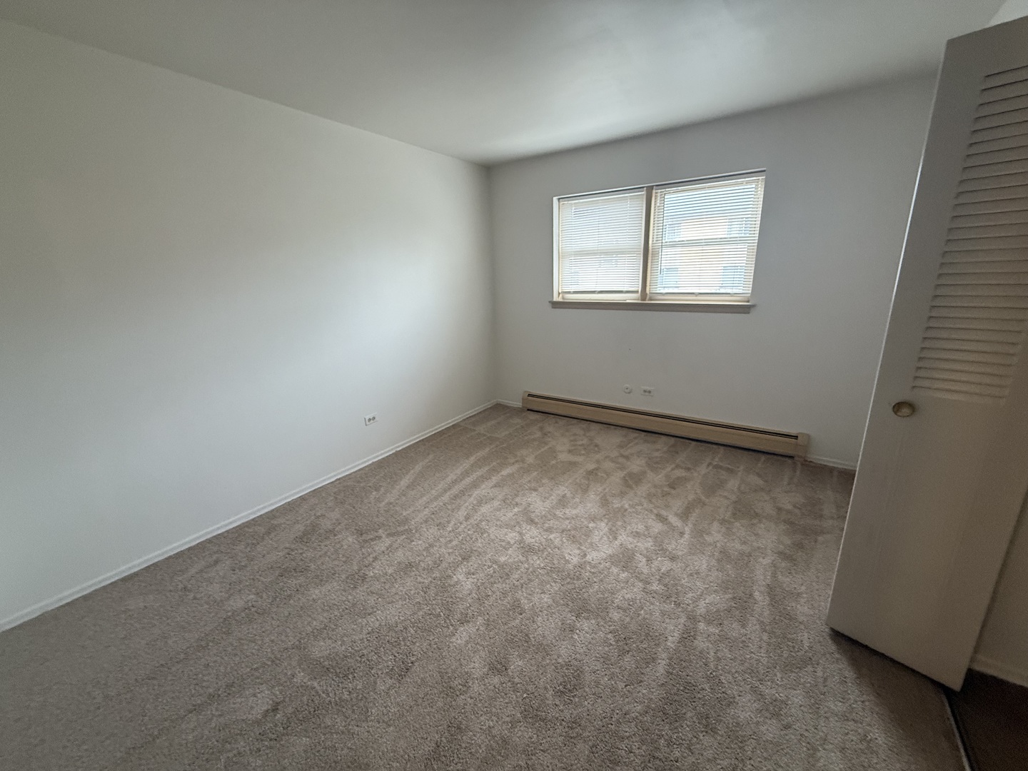 3001 Thatcher Avenue, Unit 2D River Grove, IL 60171 - Photo 7 of 11 an empty room with a window