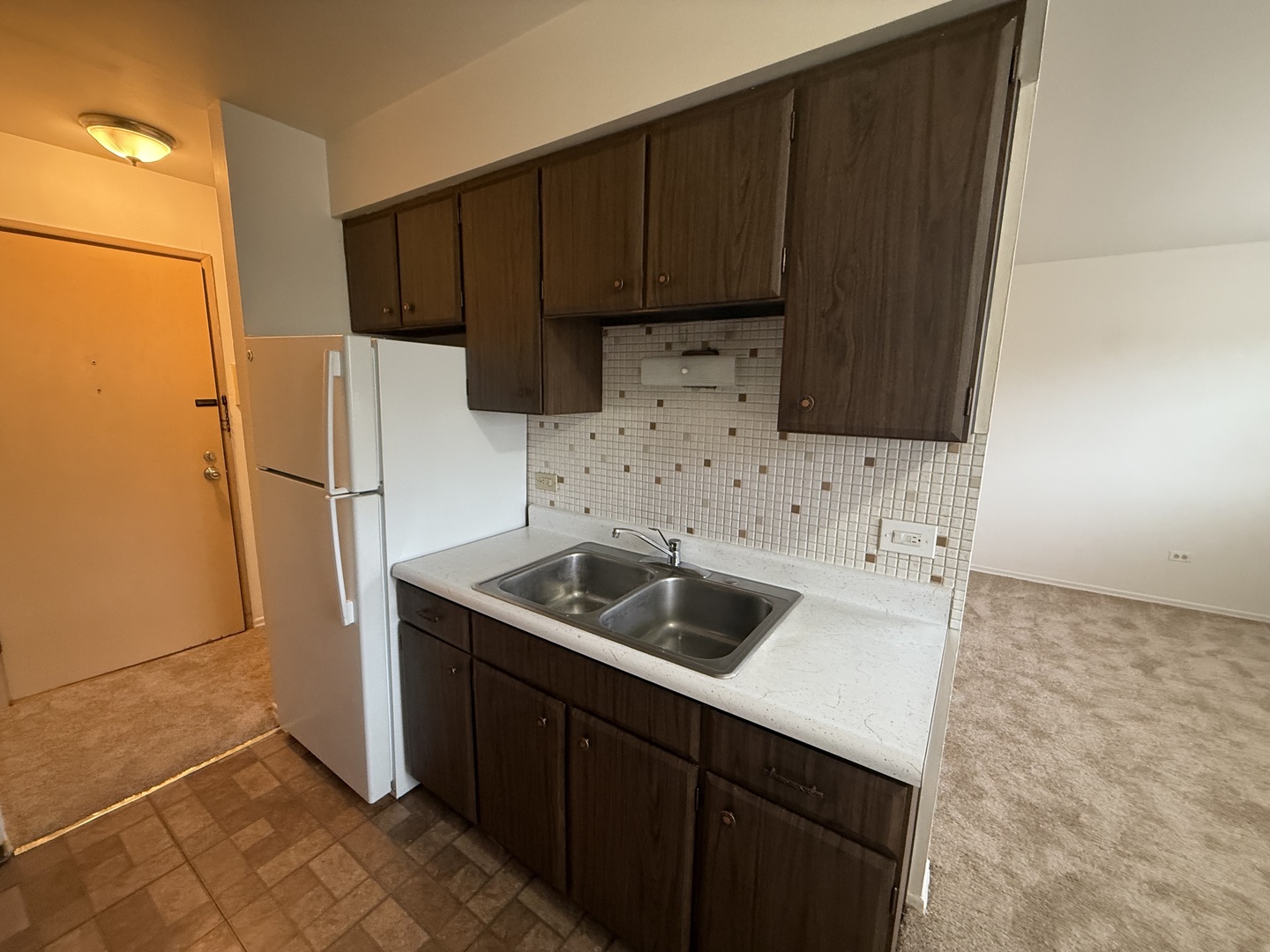 3001 Thatcher Avenue, Unit 2D River Grove, IL 60171 - Photo 9 of 11 a kitchen with a sink a refrigerator and cabinets