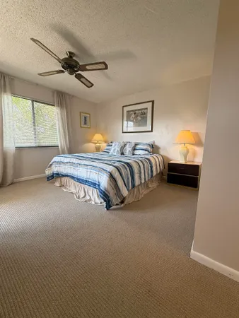 a spacious bedroom with a bed and window