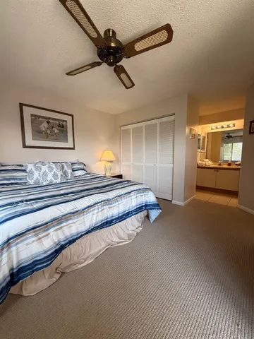 a spacious bedroom with a bed and a chandelier