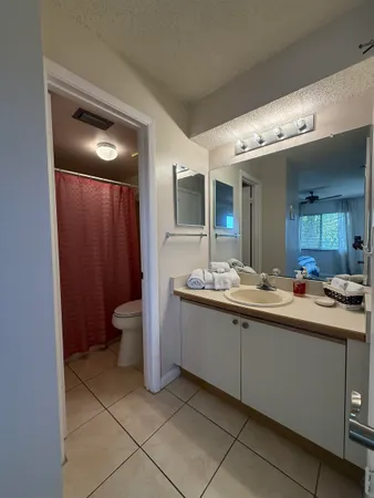 a spacious bathroom with a double vanity sink and a mirror