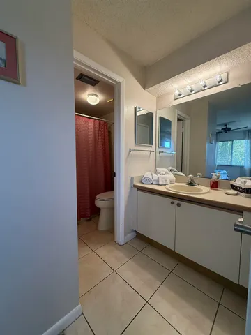 a large bathroom with a double vanity sink and a mirror