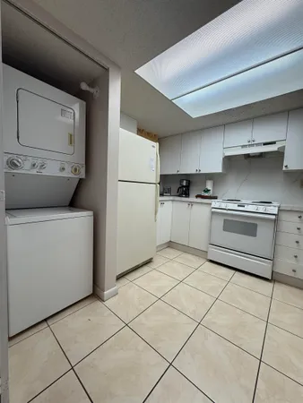 a kitchen with a stove top oven and cabinets