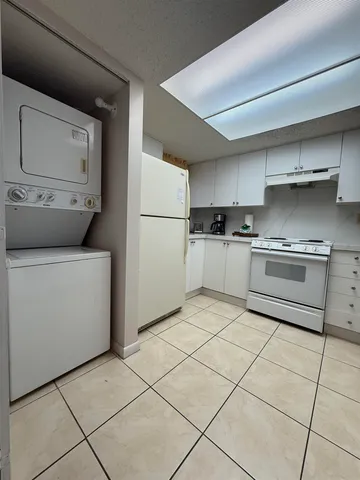 a kitchen with a stove top oven and cabinets