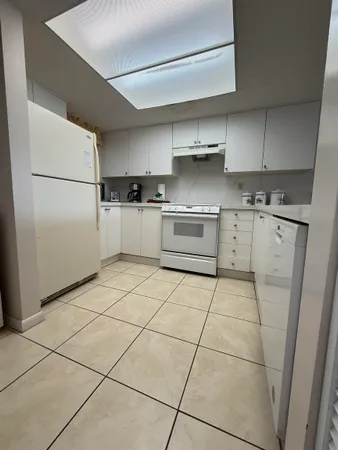 a kitchen with stainless steel appliances granite countertop a refrigerator sink and stove