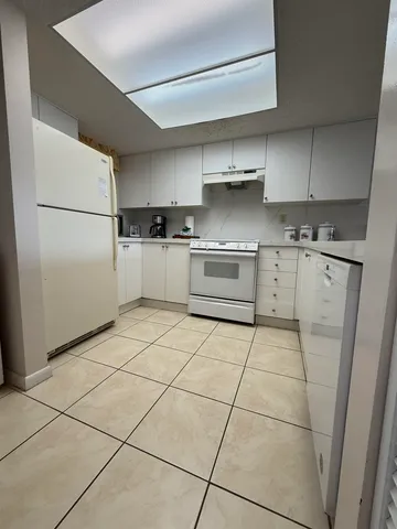 a kitchen with stainless steel appliances granite countertop a refrigerator sink and stove