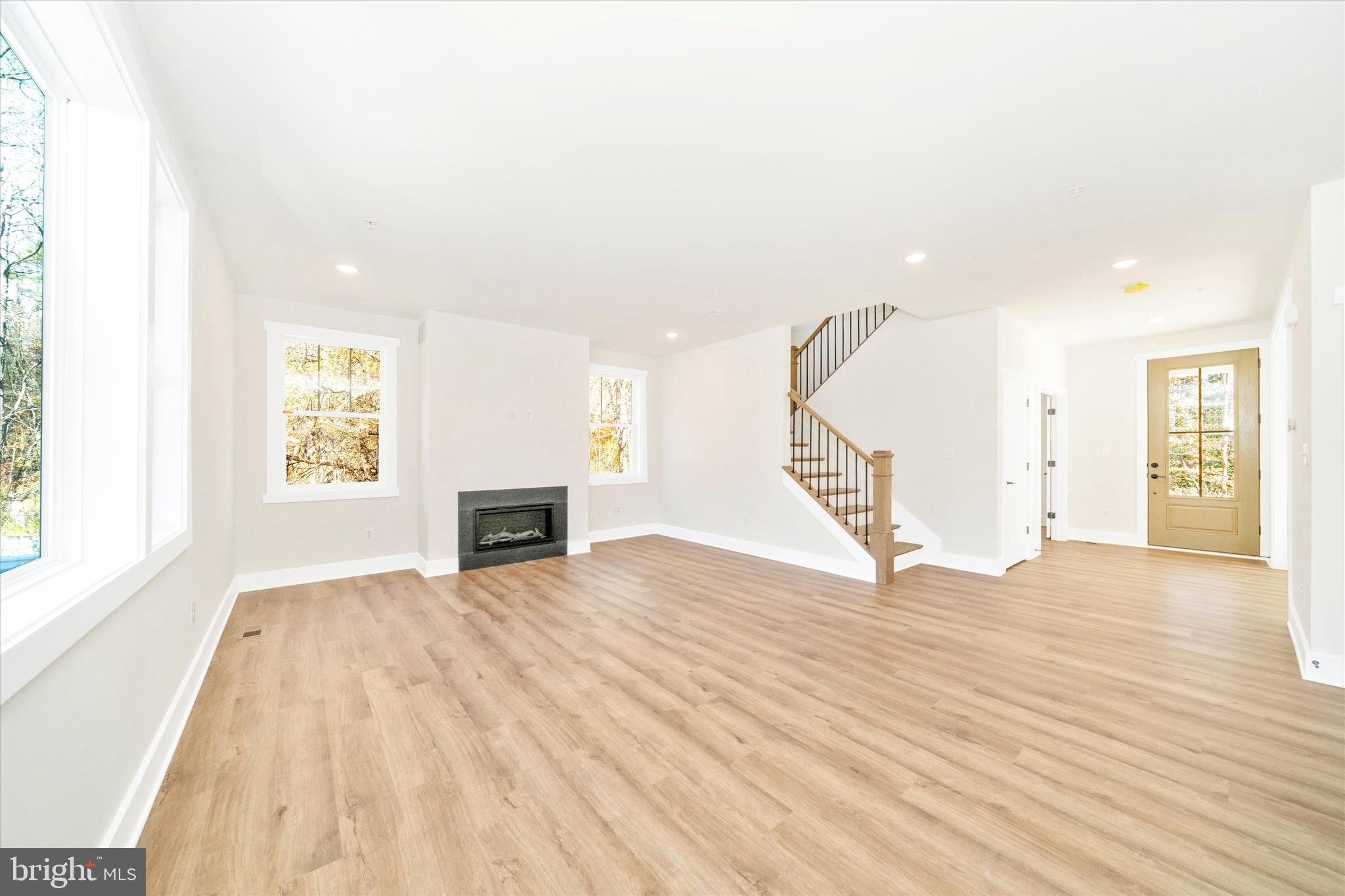 1156 Mt Zion Marlboro Road Lothian, MD 20711 - Photo 11 of 73 a view of empty room with wooden floor and fireplace