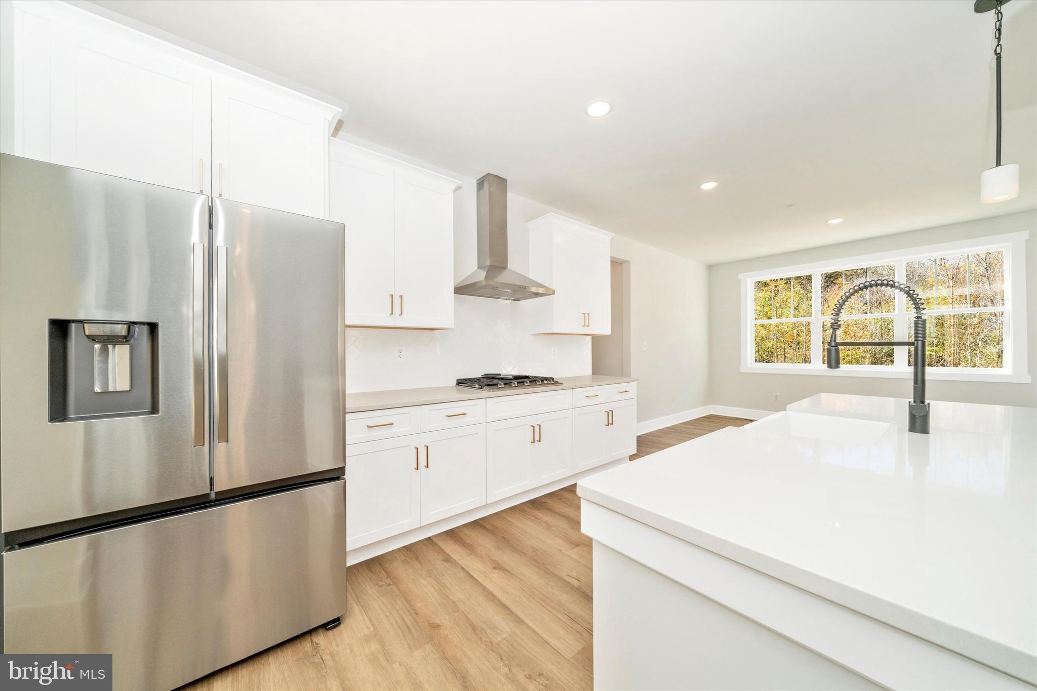1156 Mt Zion Marlboro Road Lothian, MD 20711 - Photo 22 of 73 a kitchen with stainless steel appliances a refrigerator sink and cabinets