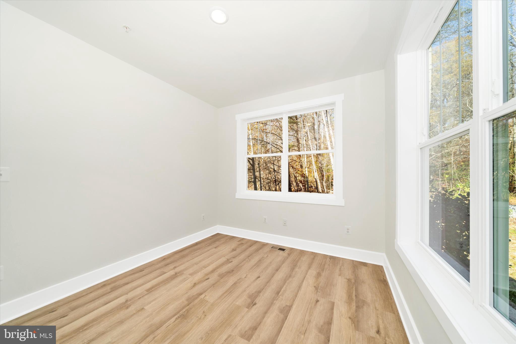 1156 Mt Zion Marlboro Road Lothian, MD 20711 - Photo 4 of 73 an empty room with wooden floor and windows