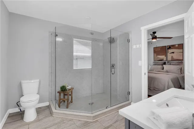 a bathroom with a sink a toilet and shower