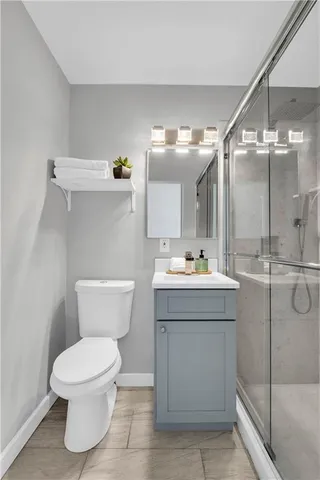 a bathroom with a sink mirror vanity and toilet