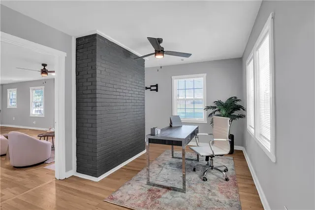 a work room with furniture and a potted plant