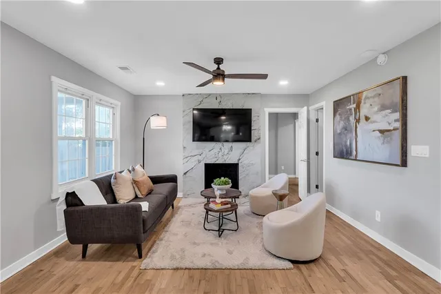 a living room with furniture a fireplace and a flat screen tv