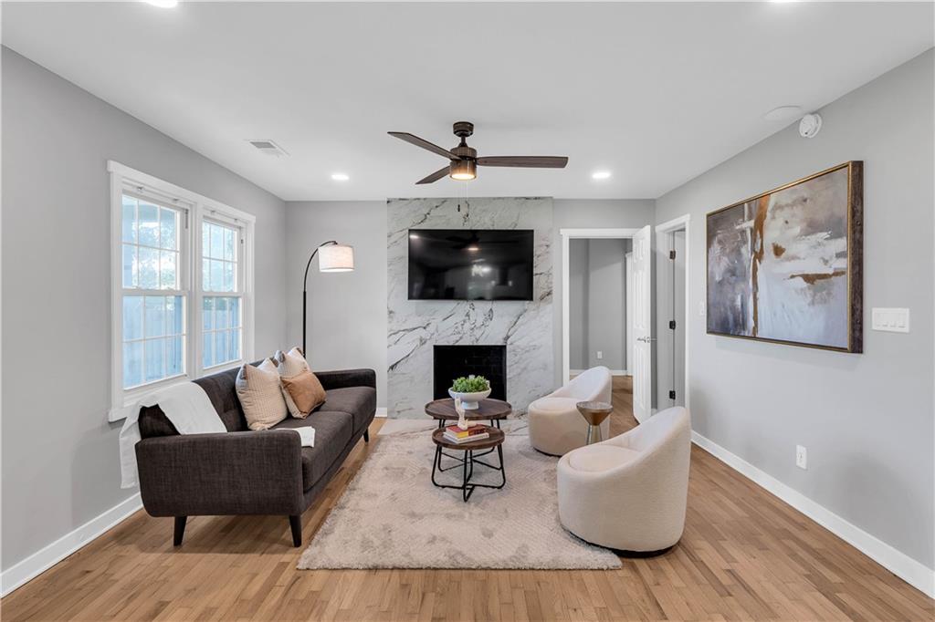 3910 Clairmont Road Atlanta, GA 30341 - Photo 3 of 16 a living room with furniture a fireplace and a flat screen tv