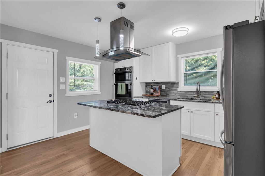3910 Clairmont Road Atlanta, GA 30341 - Photo 9 of 16 a kitchen with stainless steel appliances granite countertop a stove a sink and a refrigerator