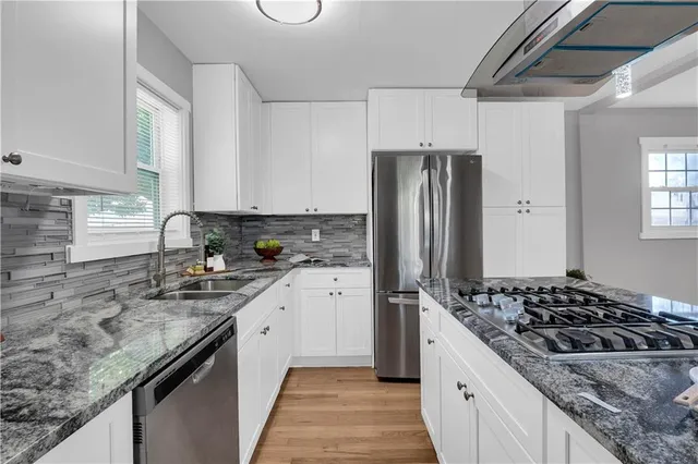 a kitchen with refrigerator stove and sink