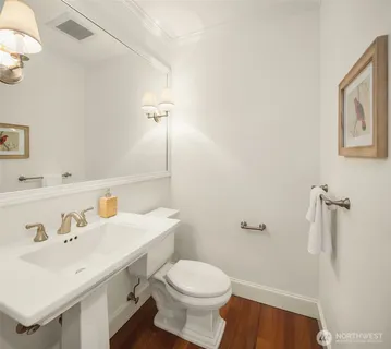 a bathroom with a sink toilet and a mirror