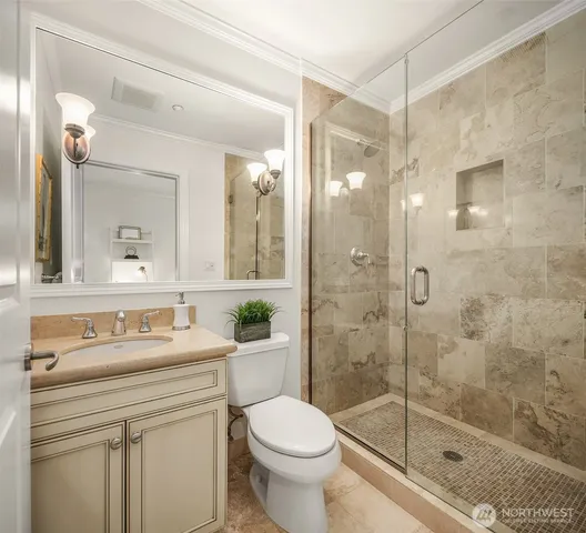 a bathroom with a sink toilet and shower