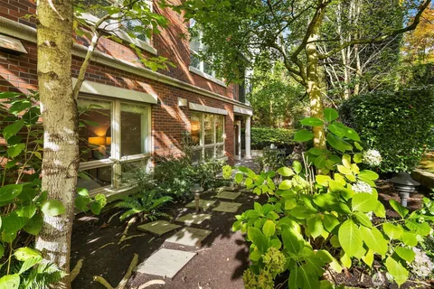 a yellow house with lots of flowers