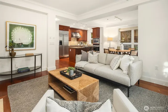 a living room with furniture and a wooden floor