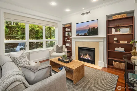 a living room with furniture a flat screen tv and a fireplace