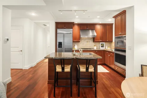 a kitchen with a table chairs sink and cabinets