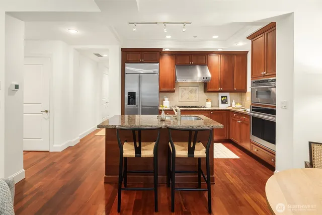 a kitchen with a table chairs sink and cabinets