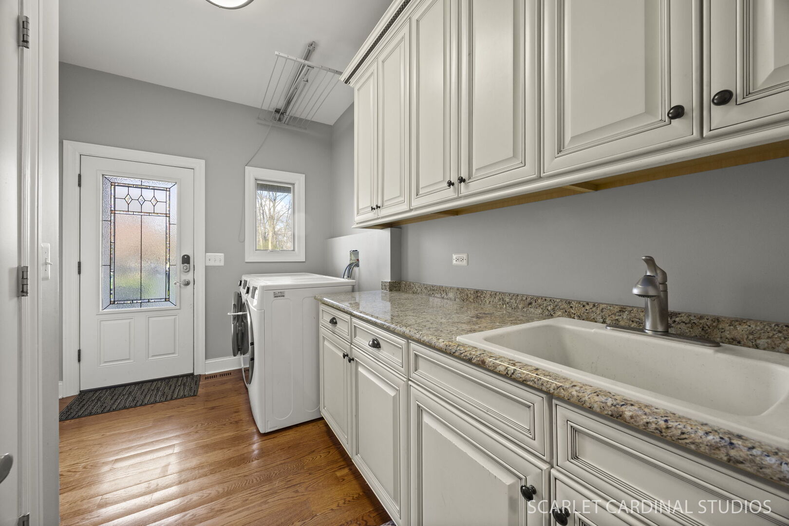 550 Edson Avenue Lombard, IL 60148 - Photo 16 of 32 a kitchen with granite countertop a sink stainless steel appliances white cabinets and a window