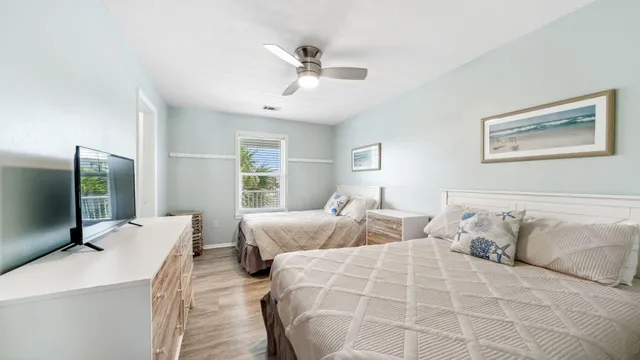 a view of bathroom with a sink mirror and window